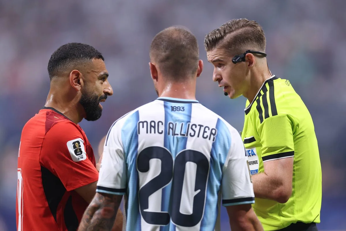 Former Liverpool teammates Mohamed Salah and Alexis Mac Allister with Referee Francois Letexier during the FIFA World Cup 2026 Round of 16 match between Argentina and Egypt. 